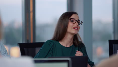 smiling businesswoman shaking hands with client in office