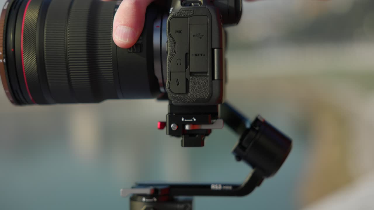 Mounting professional camera with telephoto lens on new modern DJI RS3 stabilizer gimbal