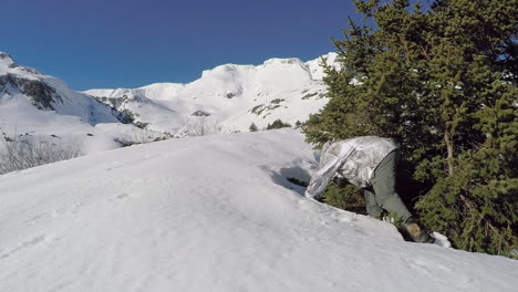 a wildlife photographer getting ready for a winter photoshoot while wearing snow camouflage in the wilderness of kodiak island alaska