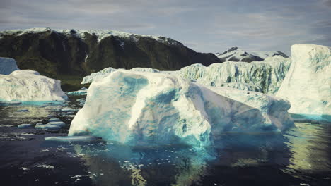 majestic icebergs floating on calm waters near towering mountains in greenland