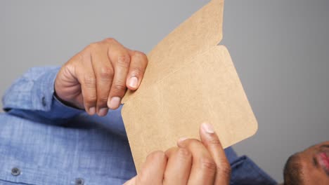 man holding a blank cardboard card