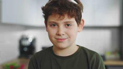 portrait of a young boy in a kitchen