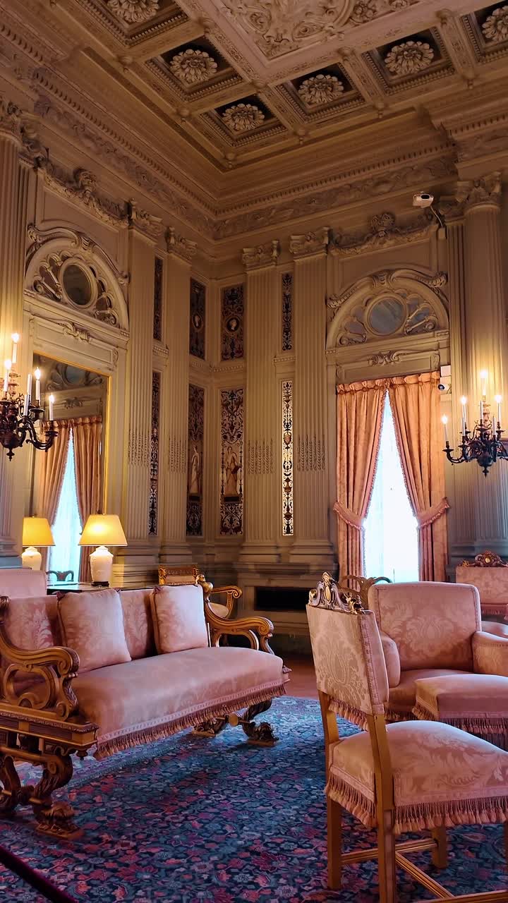 Boston, USA, 5 May 2025: Luxurious Victorian era sitting room with ornate coffered ceiling. Interior view of a room featuring pink upholstered furniture, fluted columns and a decorative gold ceiling