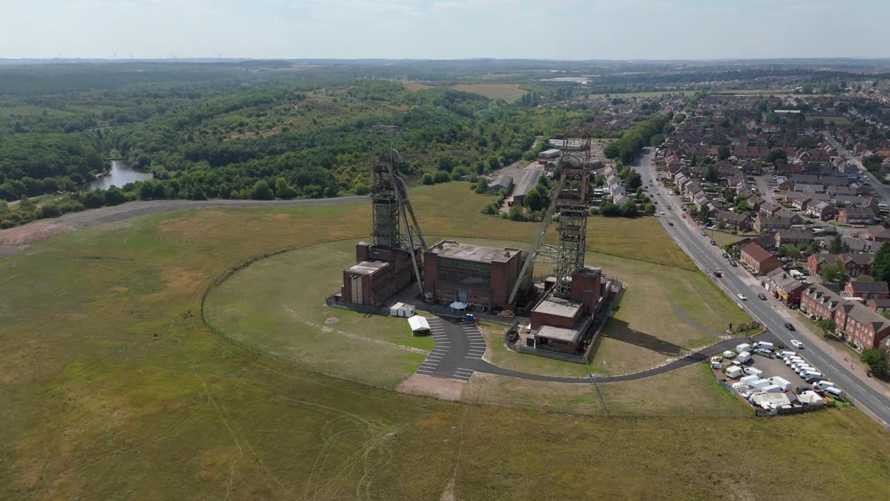Cinematic aerial drone orbit of historic coal mining headstocks industrial revolution site Clipstone Nottinghamshire England UK