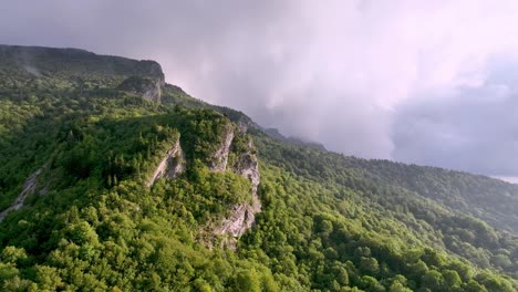 fog rolls in over the crest of grandfather mountain from linville nc, north carolina