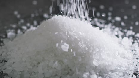 close up video of salt grains in the air on dark background