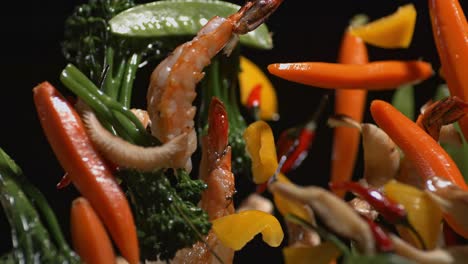 vegetables and seafood are tossed in a pan