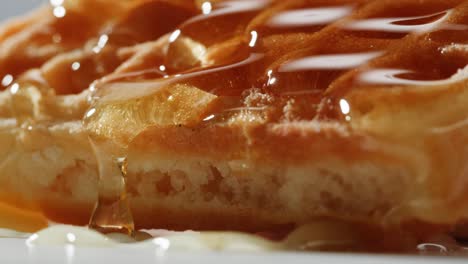 close-up of honey drizzled waffle
