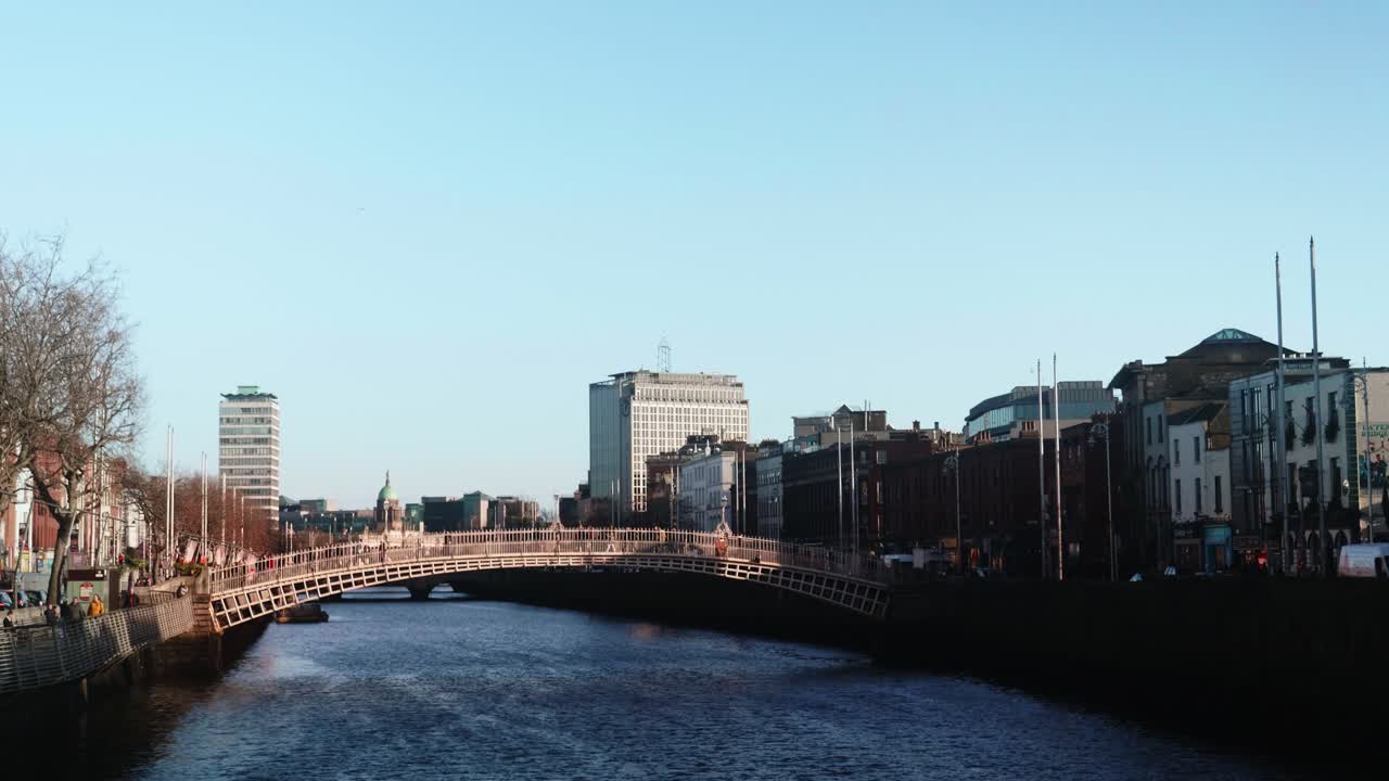 People Walking on Ha'penny Bridge Over River Liffey in Dublin
