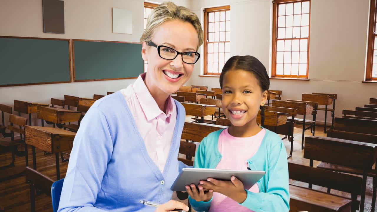 Animation of smiling caucasian female teacher and biracial schoolgirl with tablet over classroom