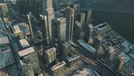 vista aérea de edificios altos en el centro de toronto, y un lago ontario congelado durante una fría y soleada tarde de invierno