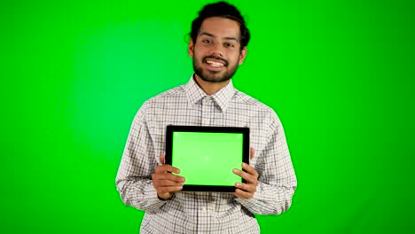 guy-using-mobile---tablet-with-green-screen-and-green-background-indian-guy-with-green-screen