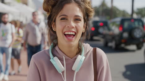 portrait of young lively woman laughing enjoying relaxed summer vacation on vibrant sunny urban beachfront slow motion