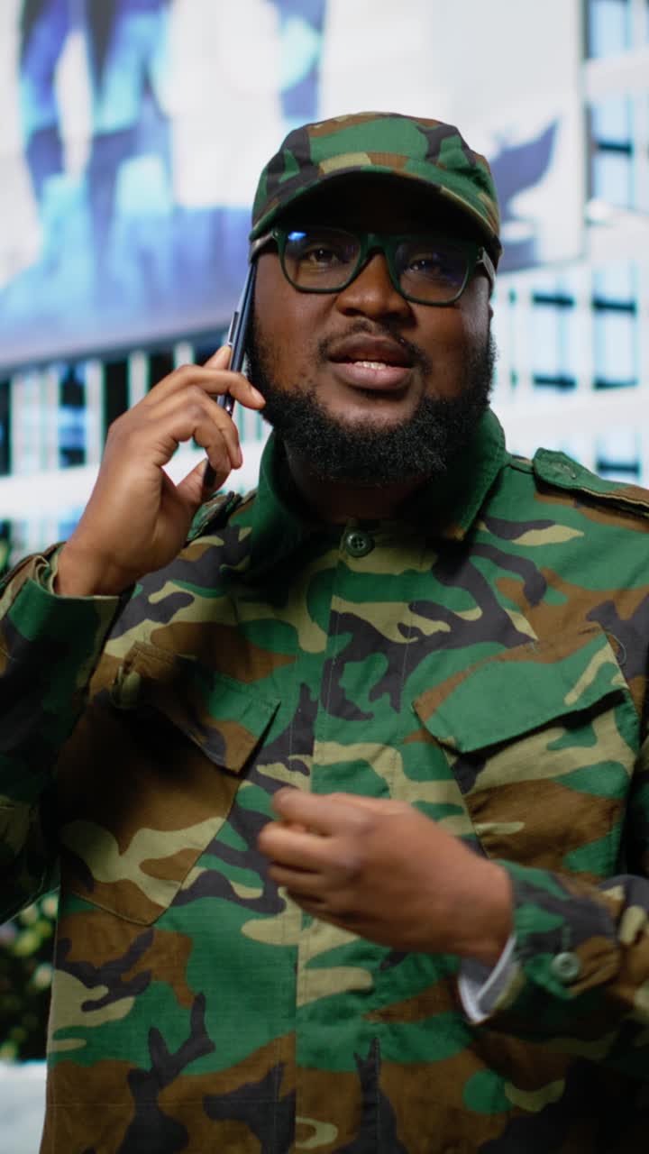 Vertical Video Black soldier in uniform answering phone call from his superior