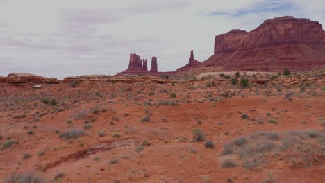 Excellent-Aerial-Shot-Of-West-Mitten-Butte,-East-Mitten-Butte,-And-Merrick-Butte-In-Monument-Valley,-Utah