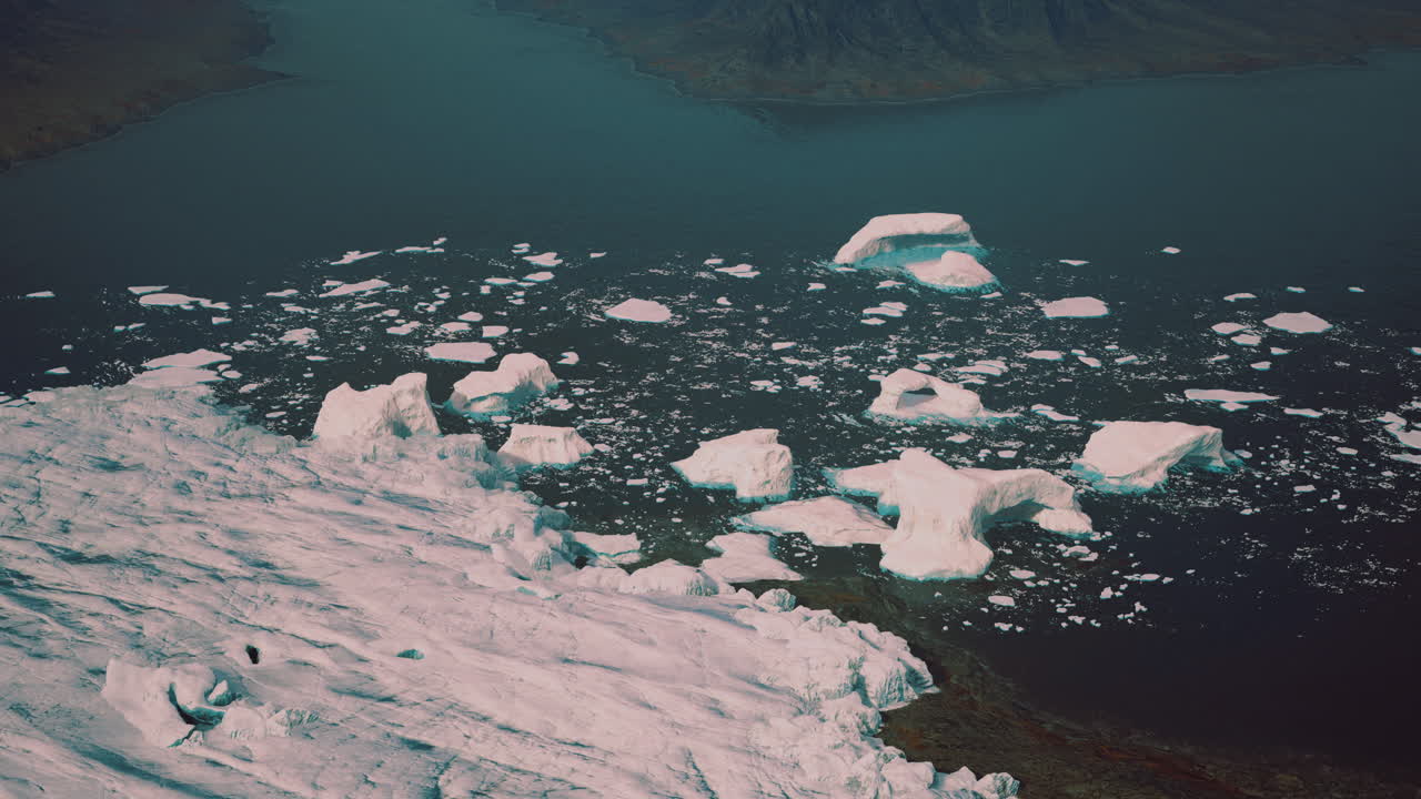 Icebergs floating in a glacial fjord during the day in a polar region