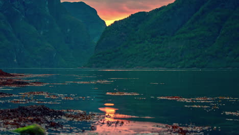 Yacht-or-cruiseship-goes-through-waterway-ocean-between-large-green-mountains,-timelapse