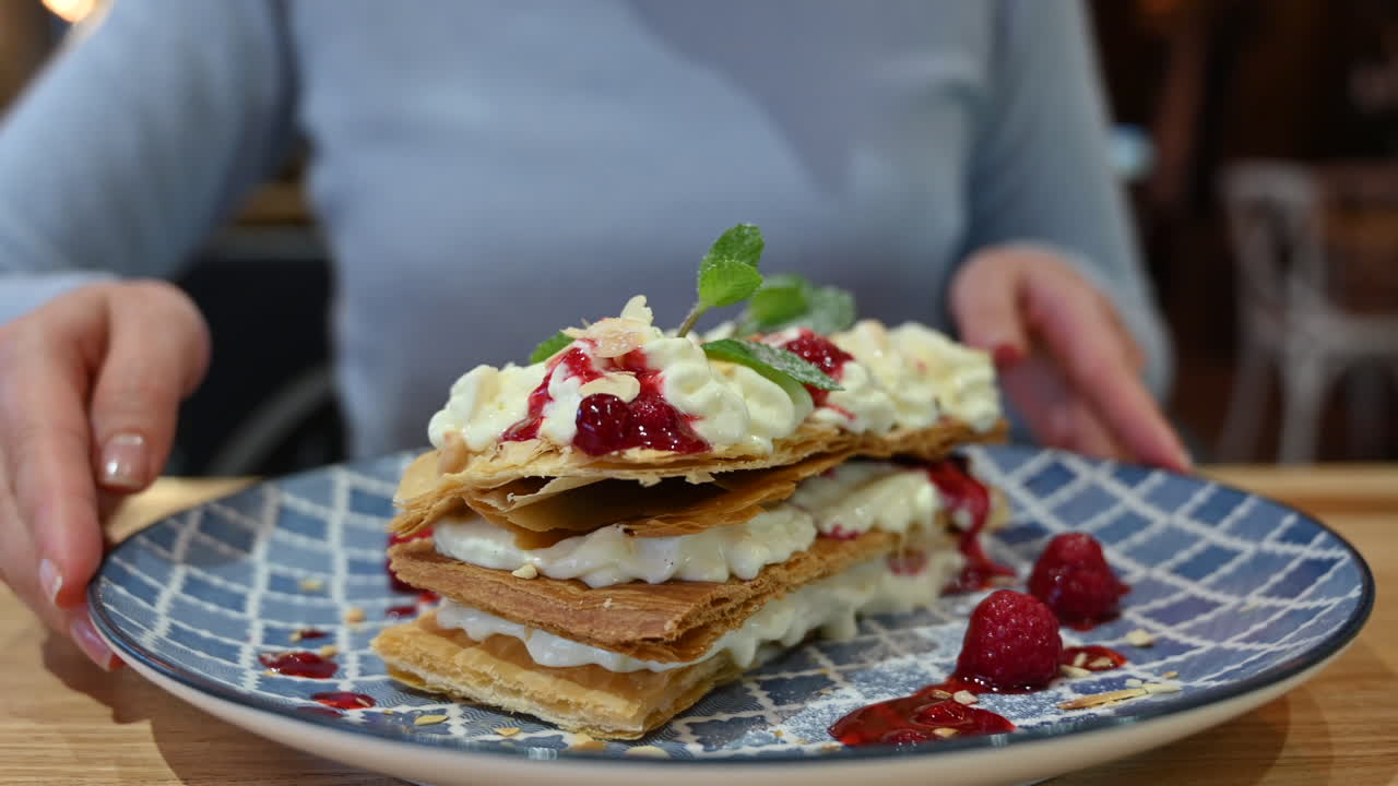 Millefeuille dessert at a restaurant in a blue plate