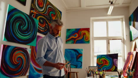 artist at work in a vibrant studio, mixing colorful paints on a palette