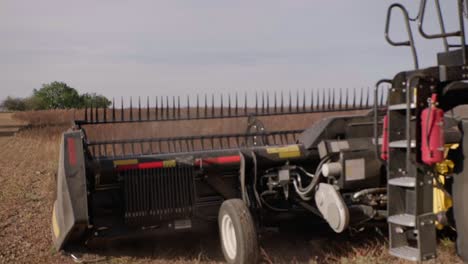 Combine-harvester-harvesting-organic-soybeans-on-sunny-day-slow-motion