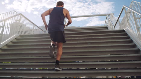 Athletic-male-exercising-on-steps-on-a-bridge