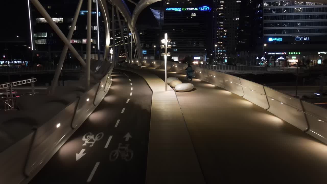 Night View of a Modern Pedestrian and Bike Bridge in a City