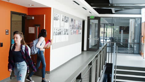 high school students and staff leaving classroom at the end of lesson