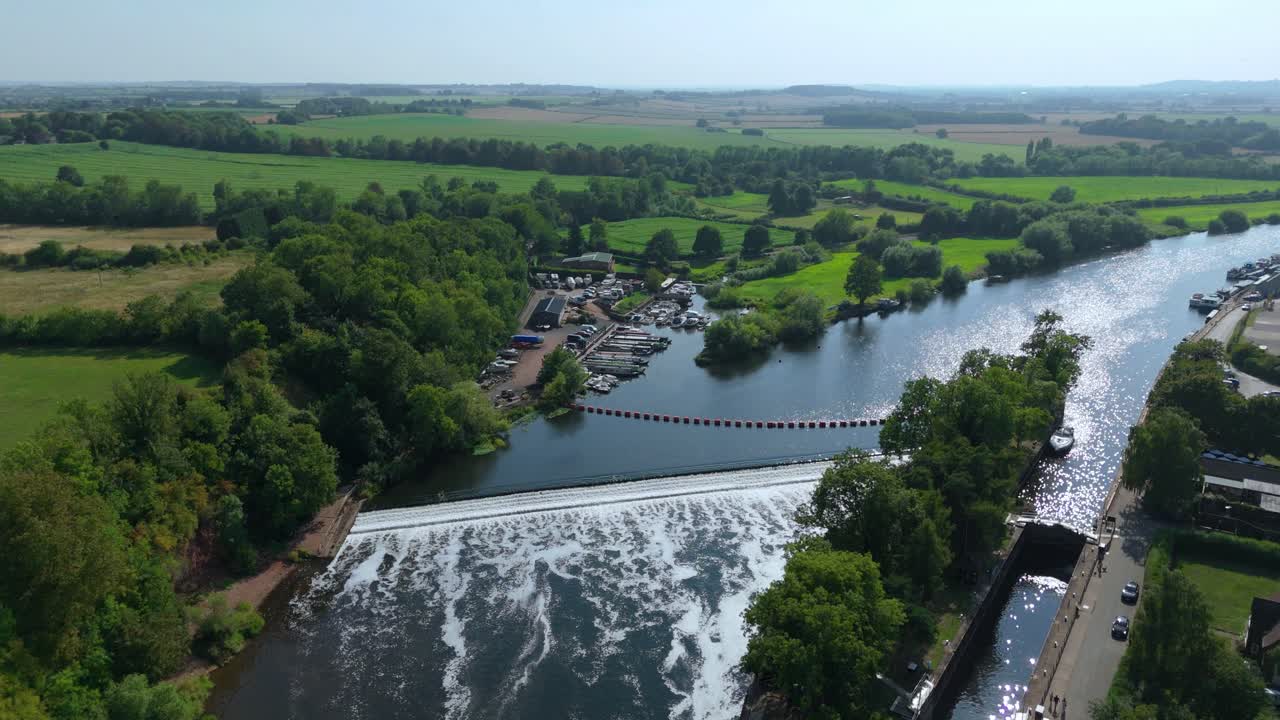 Aerial drone landscape of Gunthorpe Weir and River Trent Nottinghamshire navigation canal with peaceful rural countryside and evening summer sunset glow