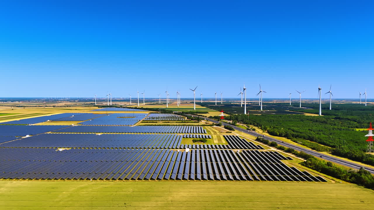 Solar and wind energy scene. Solar panels and wind turbines dominate the landscape, showcasing renewable energy production in a rural area