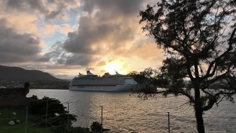 Sunset-over-big-cruise-ships-at-Puerto-Plata-port-in-Dominican-Republic,-aerial-drone-descending-view