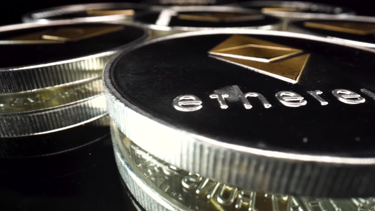 Wide-angle macro view golden Ethereum coins turning around on reflective black glass surface, ETH cryptocurrency investment altcoin 4k