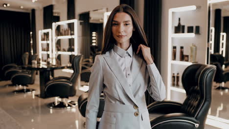 woman in a light grey suit in a modern hair salon