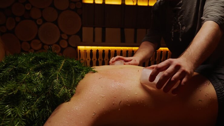 Ice therapy back massage in a wooden sauna