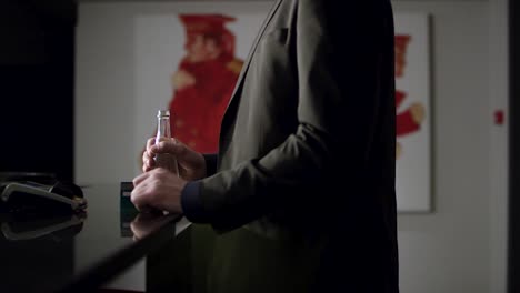 man holding a water bottle at a hotel reception desk