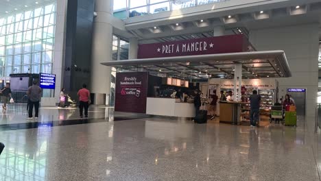 travelers move through hong kong airport terminal