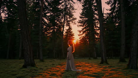 vrouw in een bos bij zonsondergang