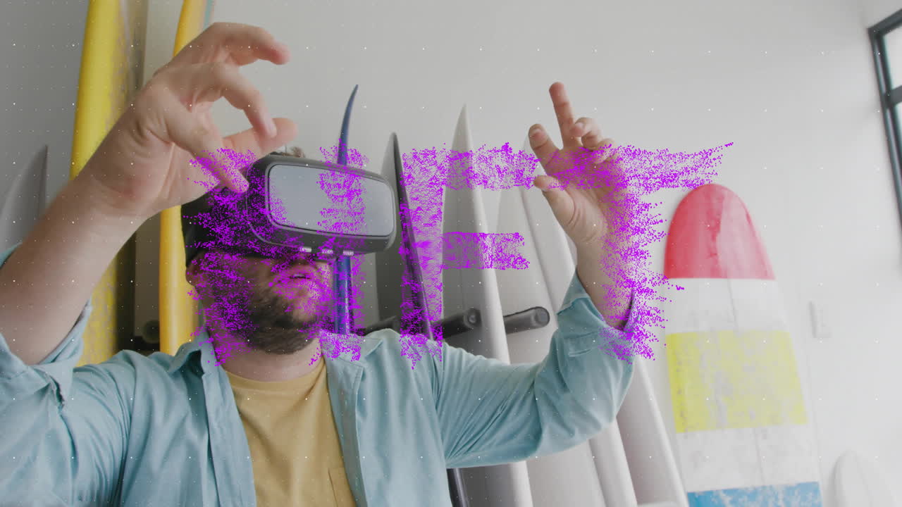 Man using virtual reality headset with purple SHIFT text animation over surfboards
