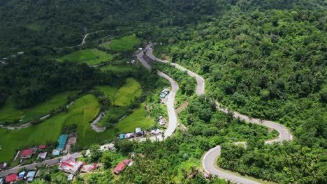 panoramic view of winding roads along lush mountains and tropical jungles in bagumbayan, bato, catanduanes -aerial drone shot