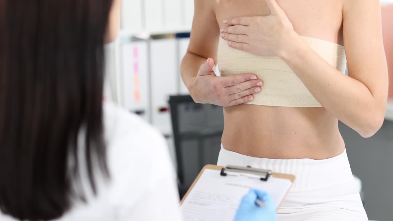 Woman with chest bandage consulting a doctor