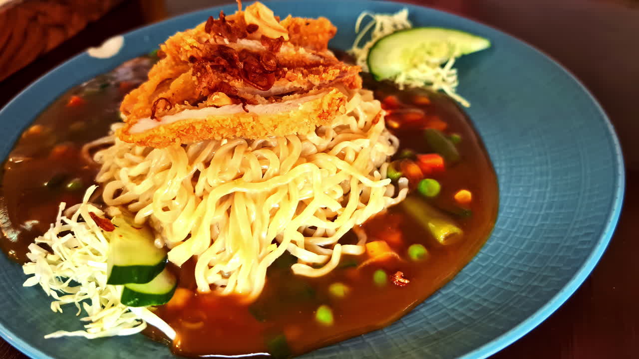 Delicious noodle dish with crispy topping in Ubud, Bali restaurant