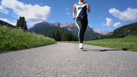 woman jogging outdoors. italy dolomites alps