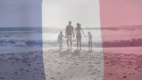 Animation-of-flag-of-france-over-biracial-couple-with-children-walking-at-beach