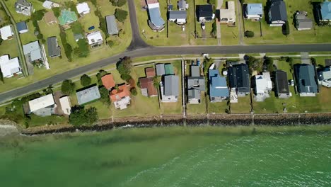 top down aerial view of beach front luxury homes along the coast