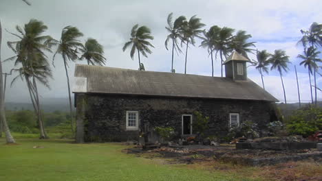 a church stands on a tropical island during a wind storm 1