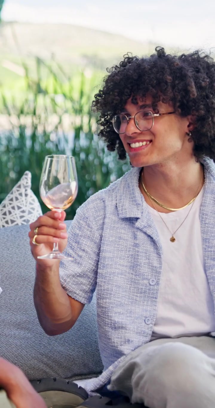 Young Man Enjoying Wine During Outdoor Social Gathering