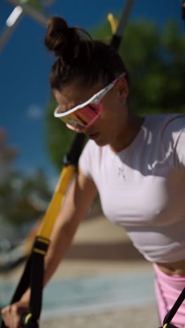 woman working out with resistance bands in a park