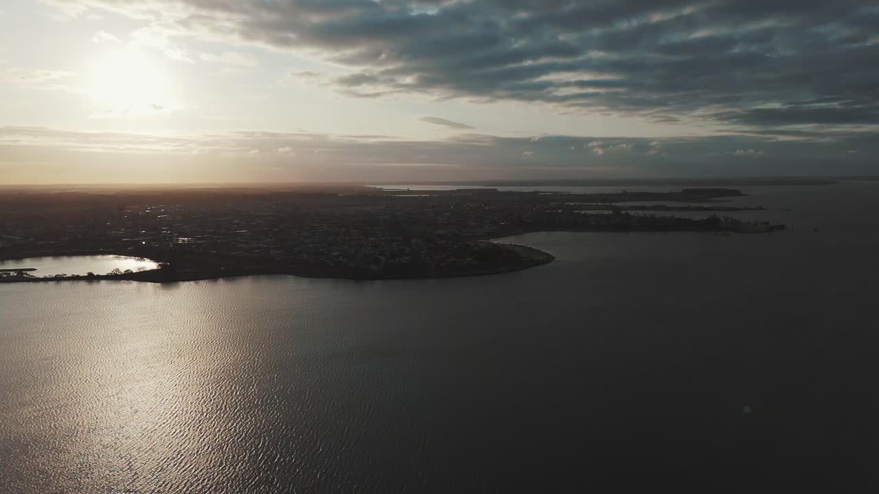 Aerial View of a City at Sunset Overlooking a Lake
