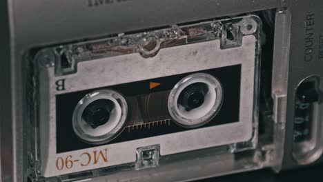 audio cassette in the tape recorder playing and rotates