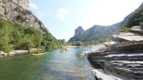 people canoeing and kayaking on the herault river france summer sunny day canyon