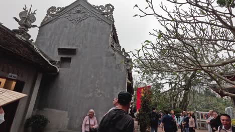 people exploring a temple courtyard in hanoi